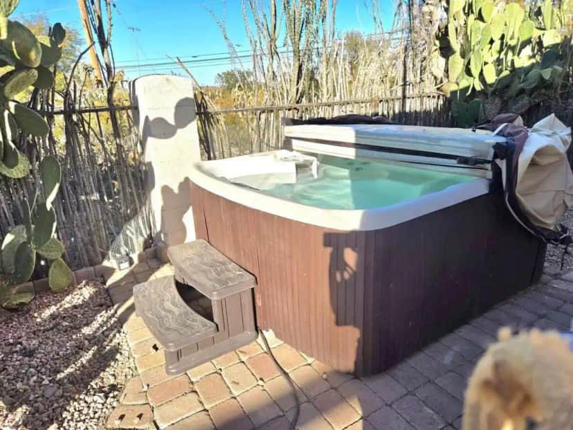 a hot tub in a yard next to a fence at 1-acre Spacious Desert Oasis Retreat near Downtown in Tucson