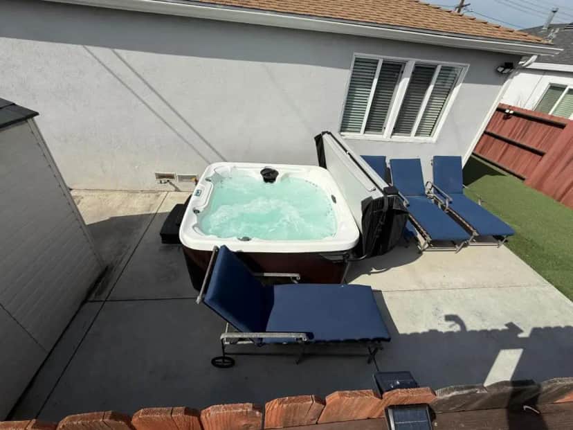 a swimming pool with chairs and a tub in a yard at 3BR Home with Backyard Hot Tub, Parking Near Beaches LAX SoFi Stadium in Lawndale
