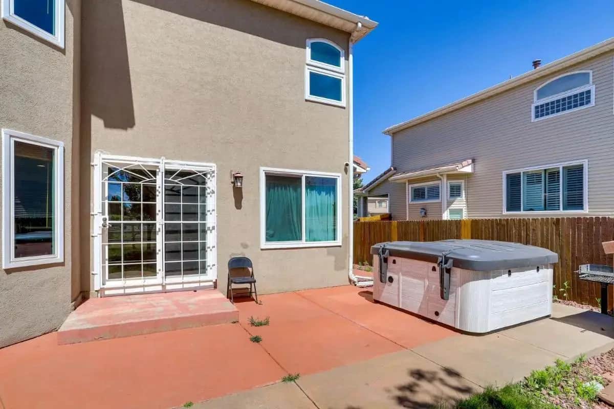 a barbecue grill on a patio in front of a house at 6bedroom 4br HOT TUB 10m to airport in DEN