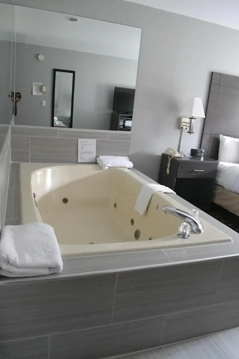 a large bath tub in a hotel room at Adams Inn and Suites in Adams