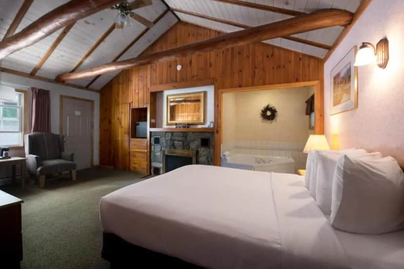 Private in-room jacuzzi in the Deluxe Jacuzzi Queen with Fireplace at Adirondack Retreat Inn & Suites