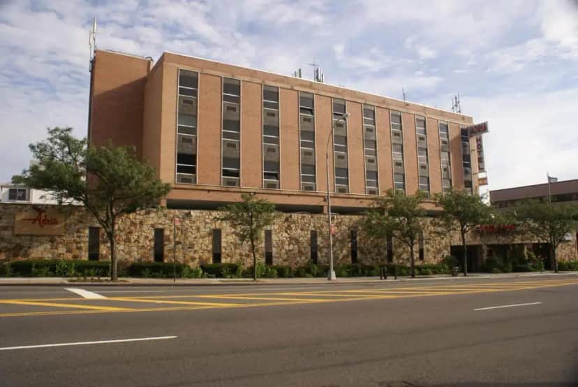 a large building on the side of a street at Adria Hotel and Conference Center in Queens