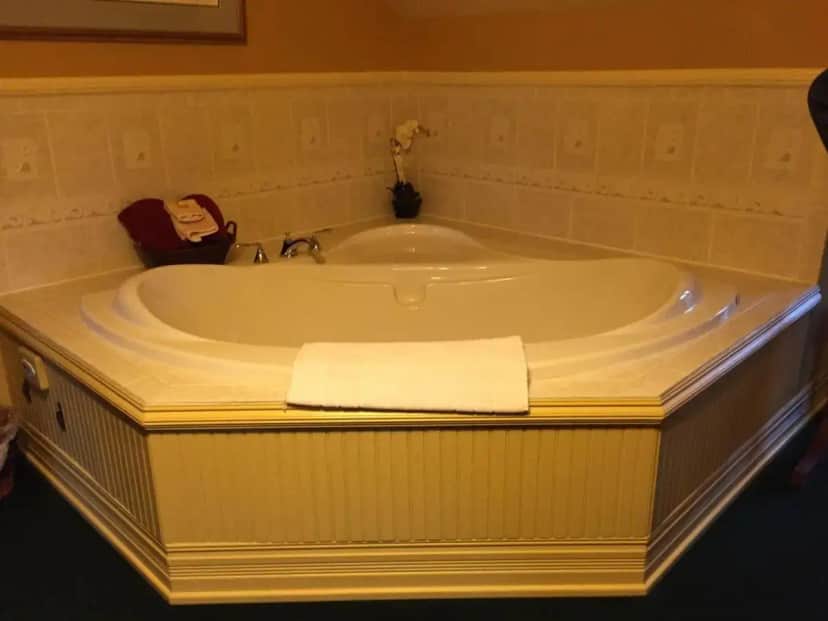 a bath tub with a towel sitting in it at Alaska's Capital Inn Bed and Breakfast in Juneau