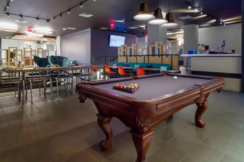 a pool table in a room with tables and chairs at Aloft by Marriott El Paso Downtown in El Paso