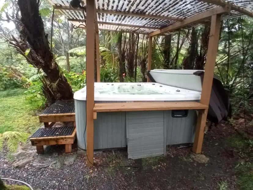 Private outdoor hot tub at Aloha Crater Lodge in Volcano, HI