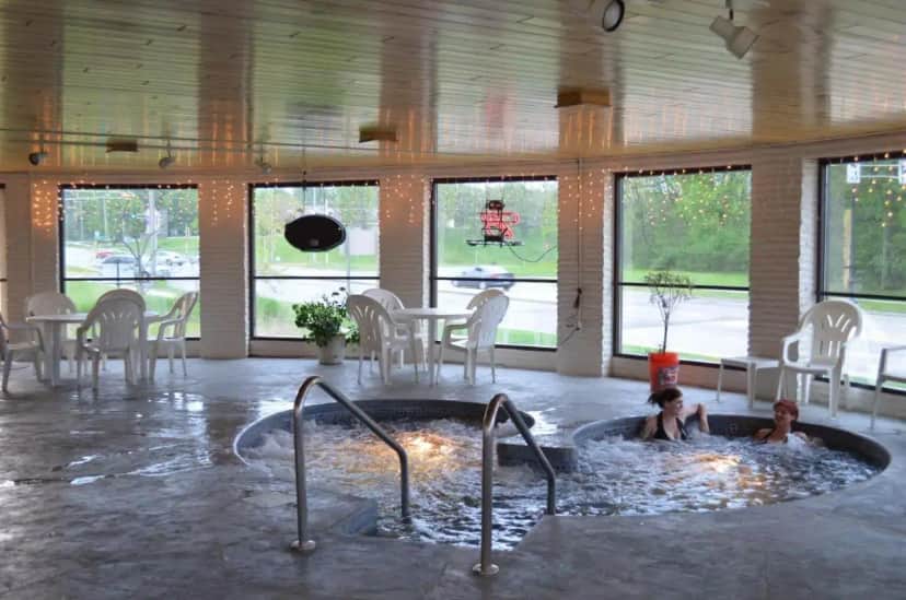 two children swimming in a hot tub in a room at Amber's Inn and Suites in Wisconsin Dells