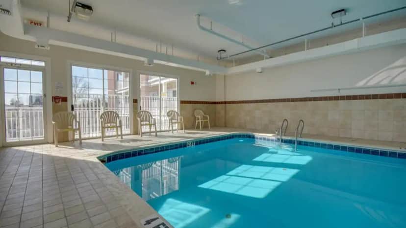 a swimming pool with blue water in a building at Americana Condos 10th street in Ocean City