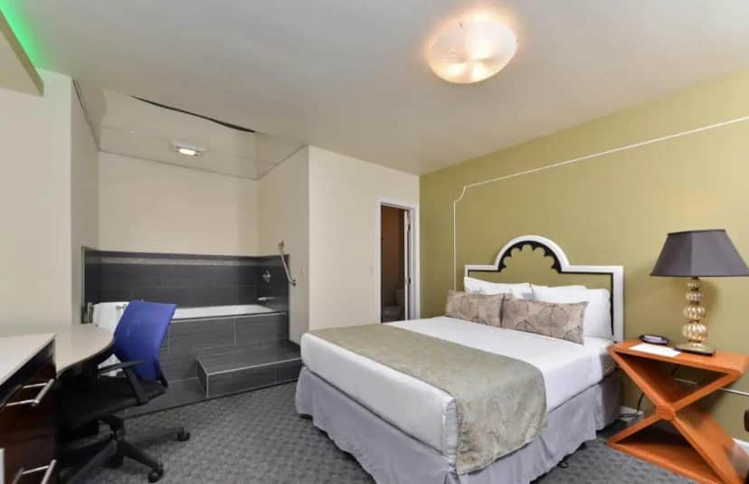 a hotel room with a bed and a bath tub at Americas Best Value Inn Rancho Palos Verdes in Rancho Palos Verdes