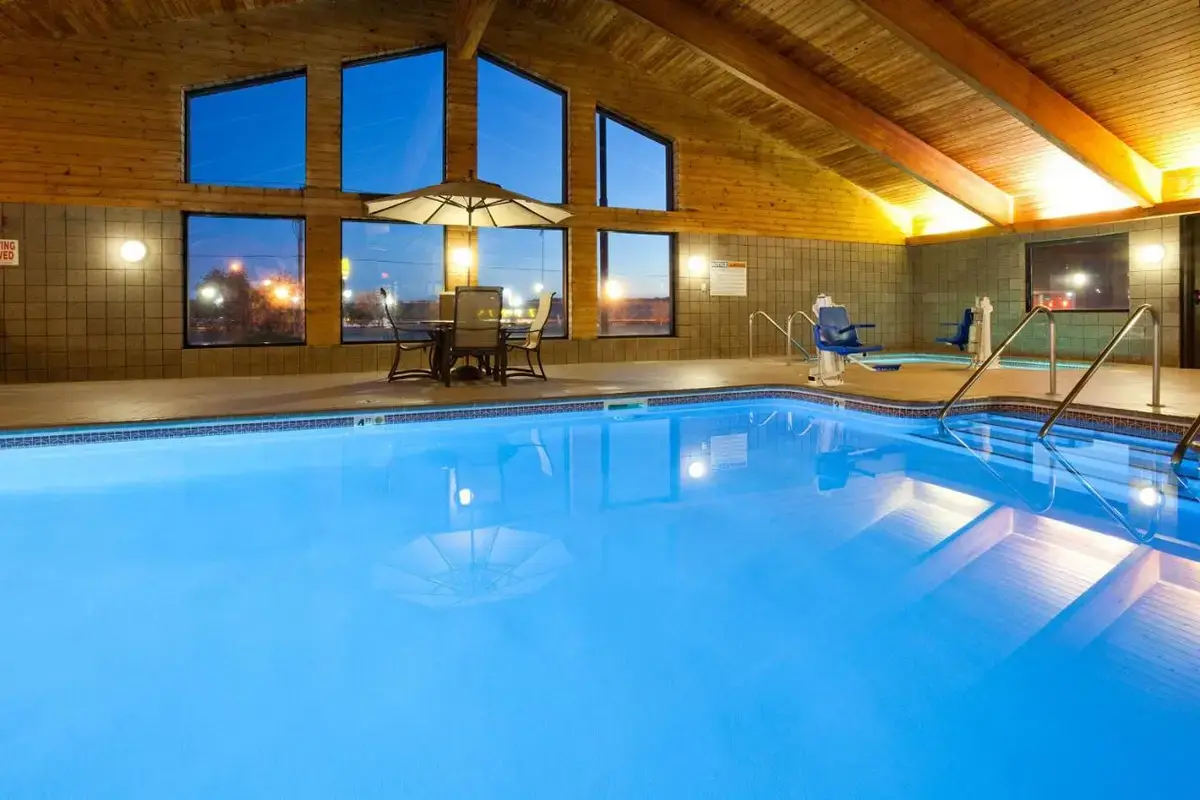 a large swimming pool in a building at AmericInn by Wyndham Eau Claire in Eau Claire