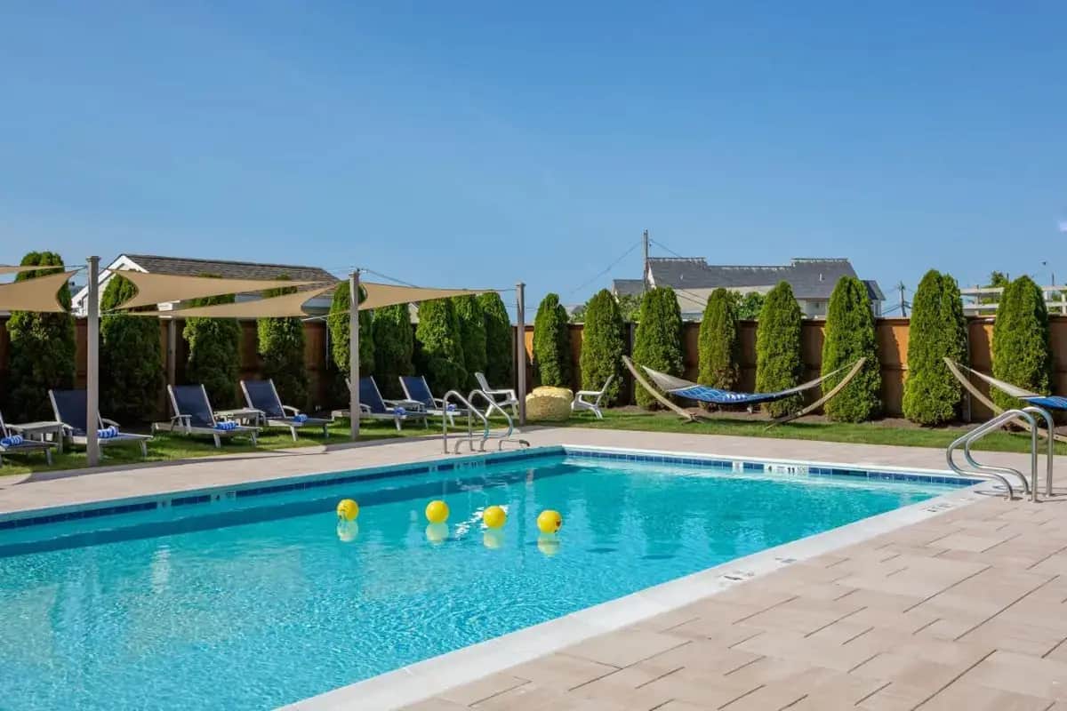 a swimming pool with volleyballs in the water at Aqualina Inn Montauk in Montauk