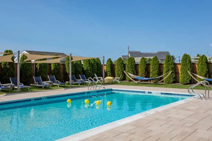 a swimming pool with volleyballs in the water at Aqualina Inn Montauk in Montauk