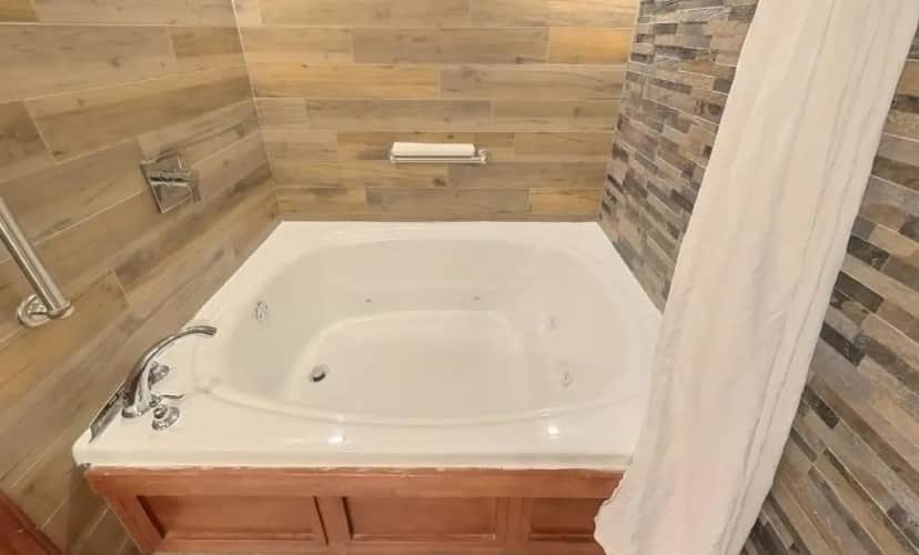 Private in-room jacuzzi tub in the Junior Suite with King Bed, Sofa Bed, Fireplace, Two Vanities, Jet Tub and Share