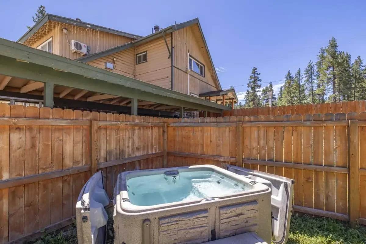 a hot tub in the backyard of a fence at Bear Creek Resort in Big Bear Lake