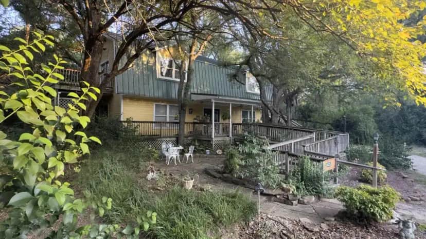 a house with two dogs standing in front of it at Bed & Breakfast on White Rock Creek in Waco