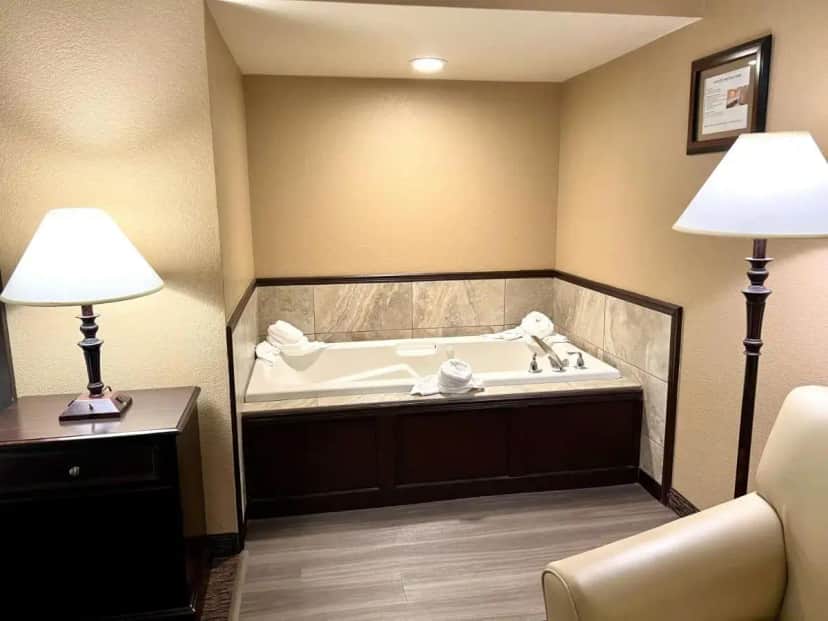 a bath tub in a room with two lamps at Best Western Country Inn in Fortuna