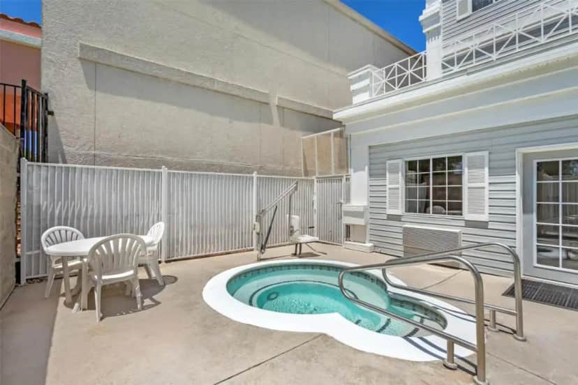 a patio with a hot tub and a table and chairs at Best Western Luxury Inn in Tracy