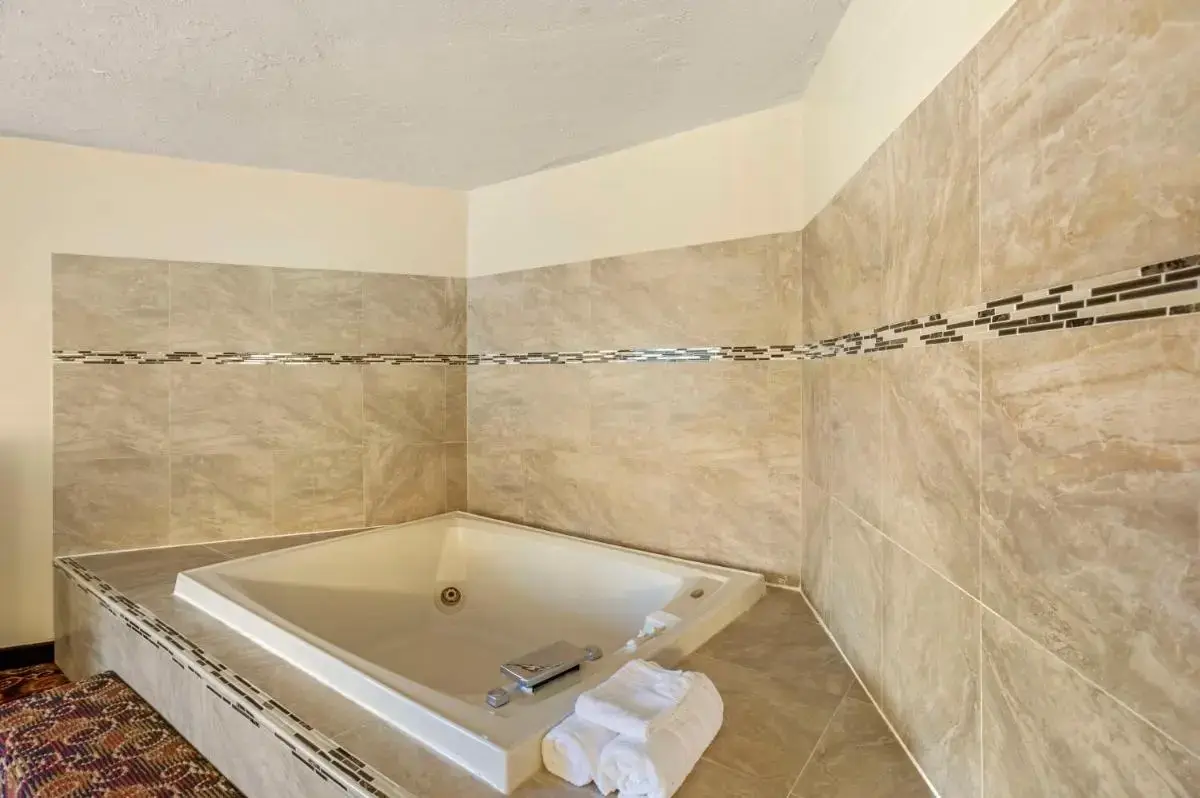 a bathroom with a bath tub in a room at Best Western Monticello in Monticello