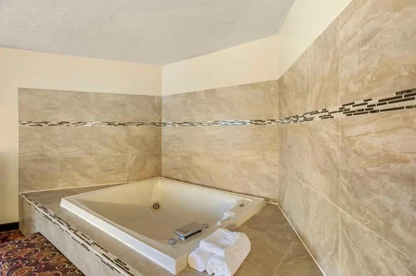 a bathroom with a bath tub in a room at Best Western Monticello in Monticello
