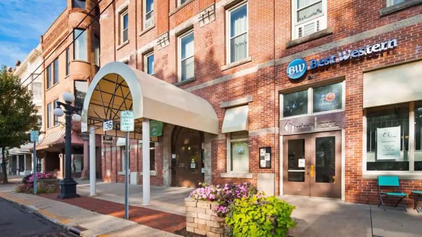 a brick building on a street with a store at Best Western Park Hotel in Warren