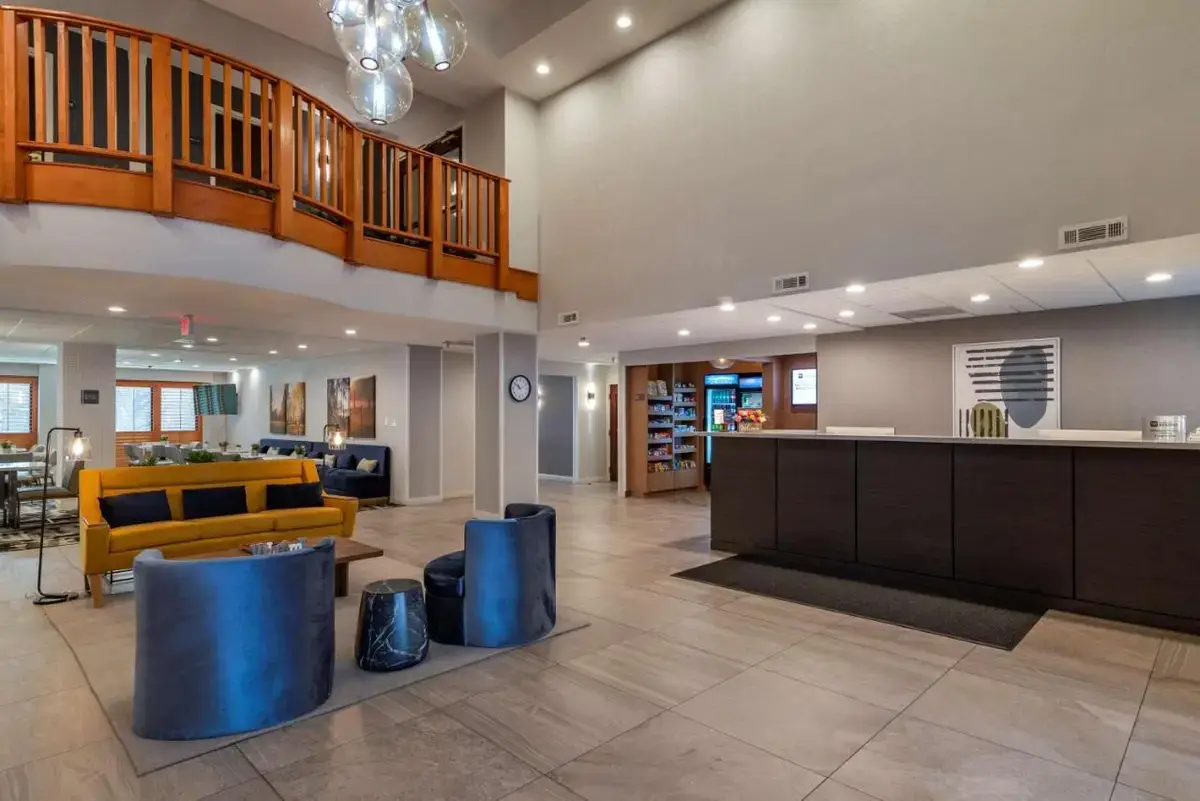 a large lobby with a yellow couch and a table at Best Western Plus Dalton Inn in Dalton