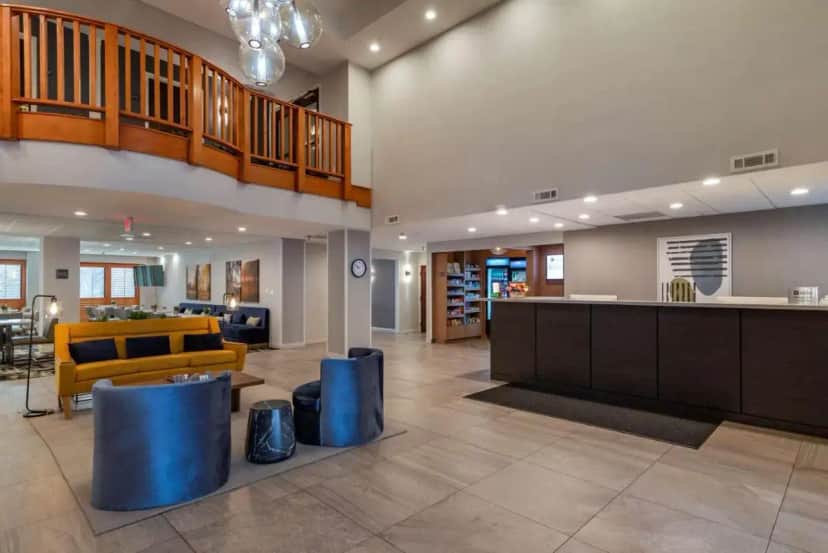 a large lobby with a yellow couch and a table at Best Western Plus Dalton Inn in Dalton