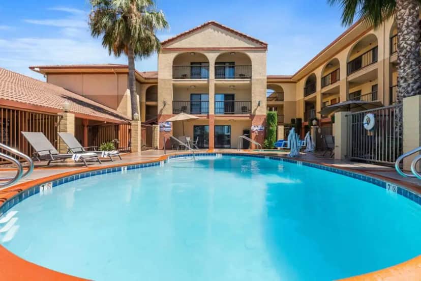 a large blue swimming pool in front of a hotel at Best Western Plus Executive Inn & Suites in Manteca
