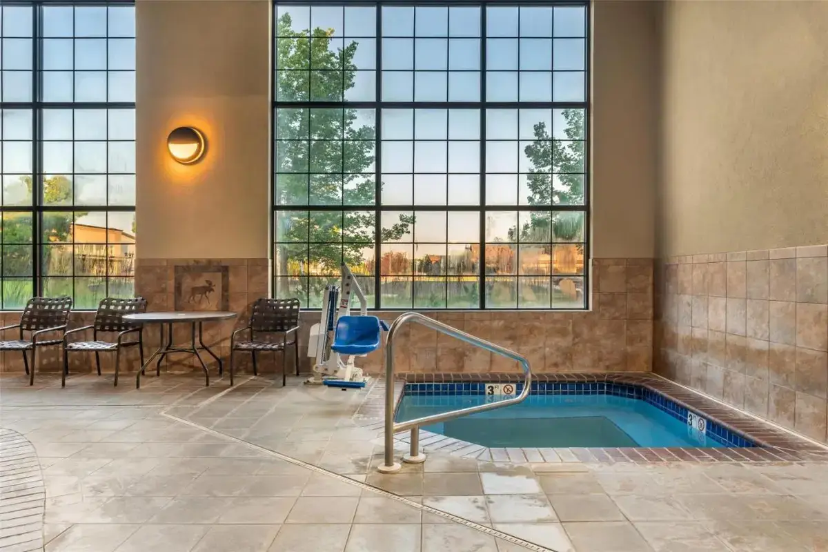 a jacuzzi tub in a room with windows at Best Western Plus Kelly Inn & Suites in Billings