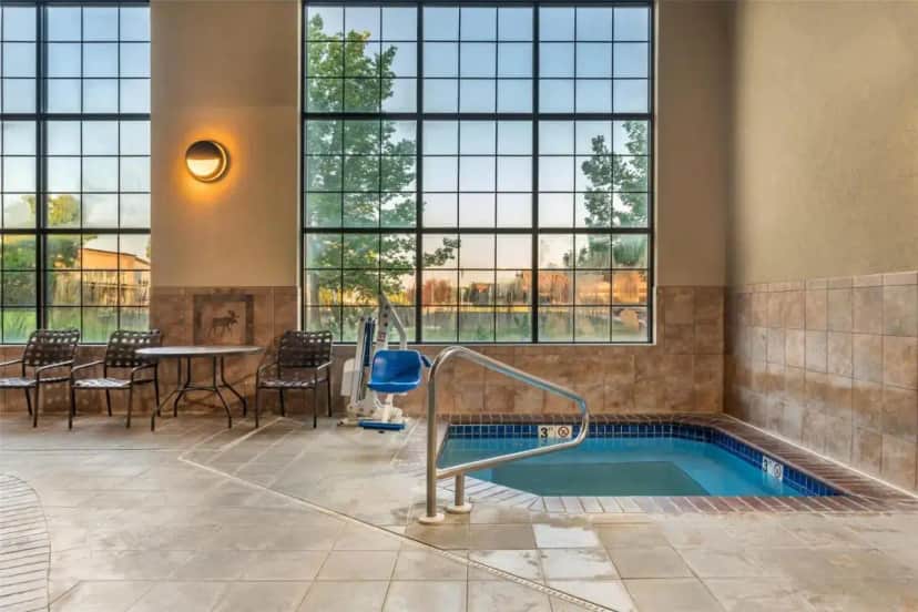 a jacuzzi tub in a room with windows at Best Western Plus Kelly Inn & Suites in Billings