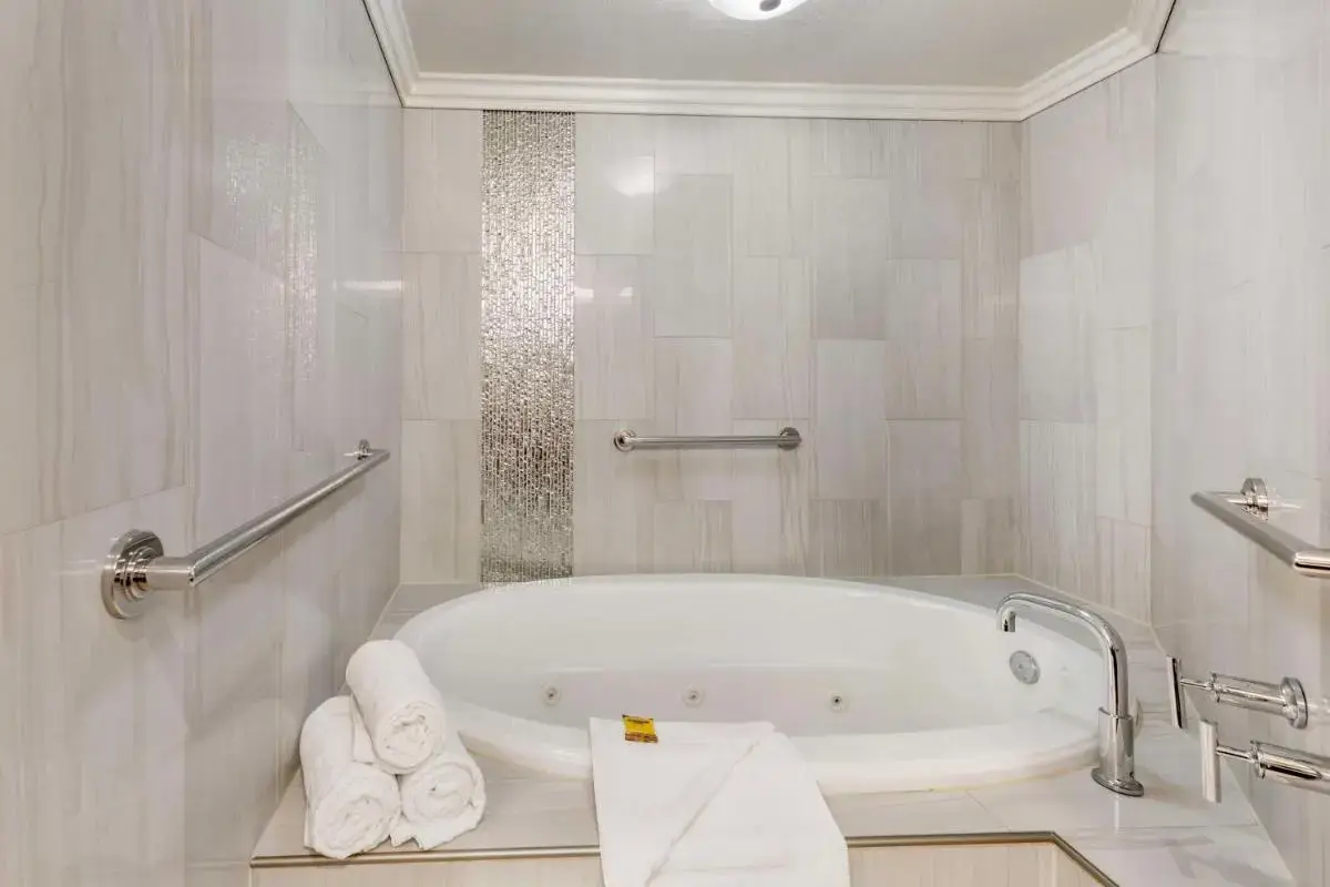 a white bathroom with a tub and towels at Best Western Plus Redondo Beach Inn in Redondo Beach