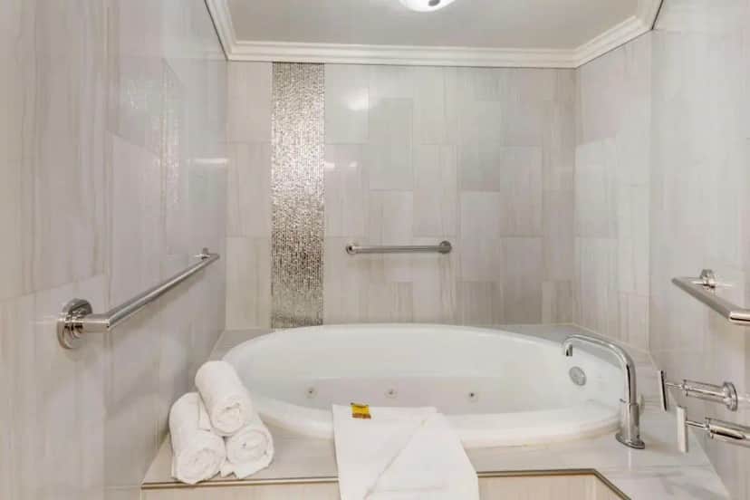 a white bathroom with a tub and towels at Best Western Plus Redondo Beach Inn in Redondo Beach