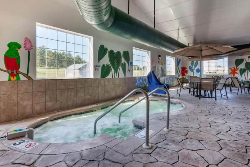 a swimming pool with a hot tub in a building at Best Western PLUS Sparta Trail Lodge in Sparta