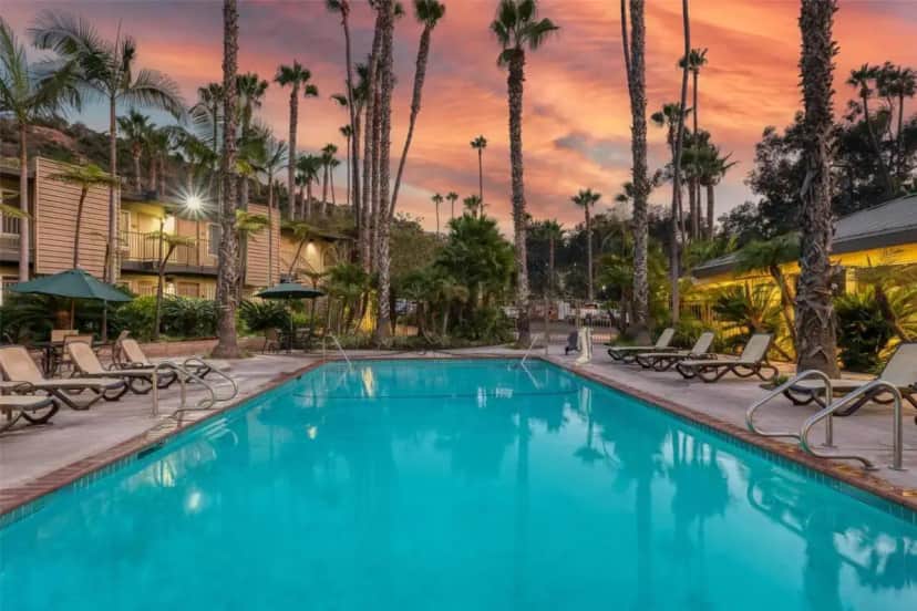 a swimming pool at a resort with palm trees at Best Western Seven Seas in San Diego