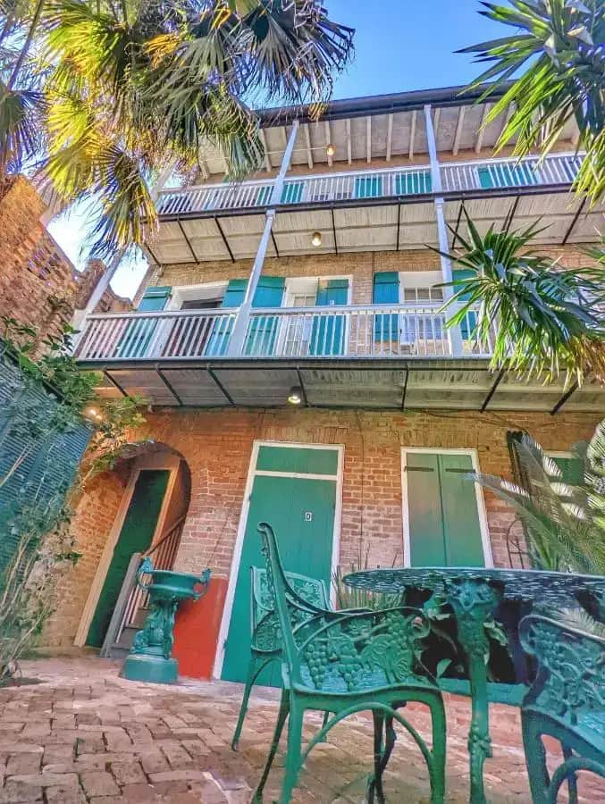 a building with a green bench in front of it at Bon Maison Guest House in New Orleans