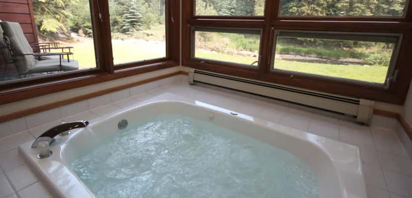 In-room hot tub at Boulder Brook on Fall River in Estes Park, CO
