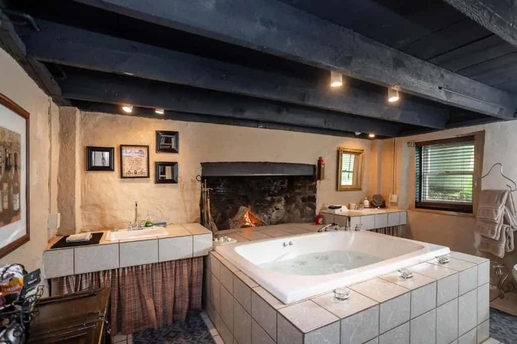 Private in-room jacuzzi tub in the King Room with Spa Bath at By The Side Of The Road Inn & Cottages