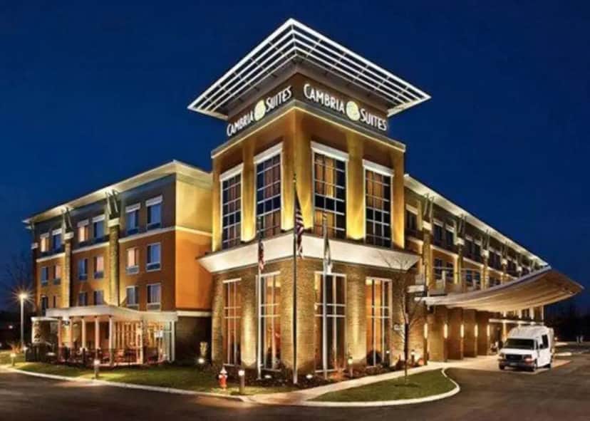 a building with a van parked in front of it at Cambria Hotel Columbus - Polaris in Flint