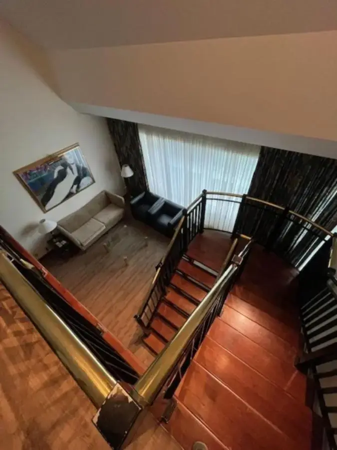 an overhead view of a living room with a staircase at Cambridge Suites Toronto in Toronto
