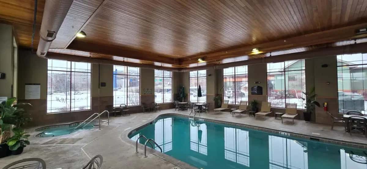 a large swimming pool in a building with windows at Canal Park Lodge in Duluth