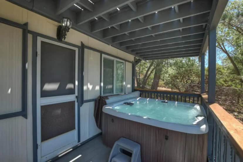a hot tub on the deck of a house at Casa Del Lago - Spacious 4 Story Gated Home in Lake Arrowhead