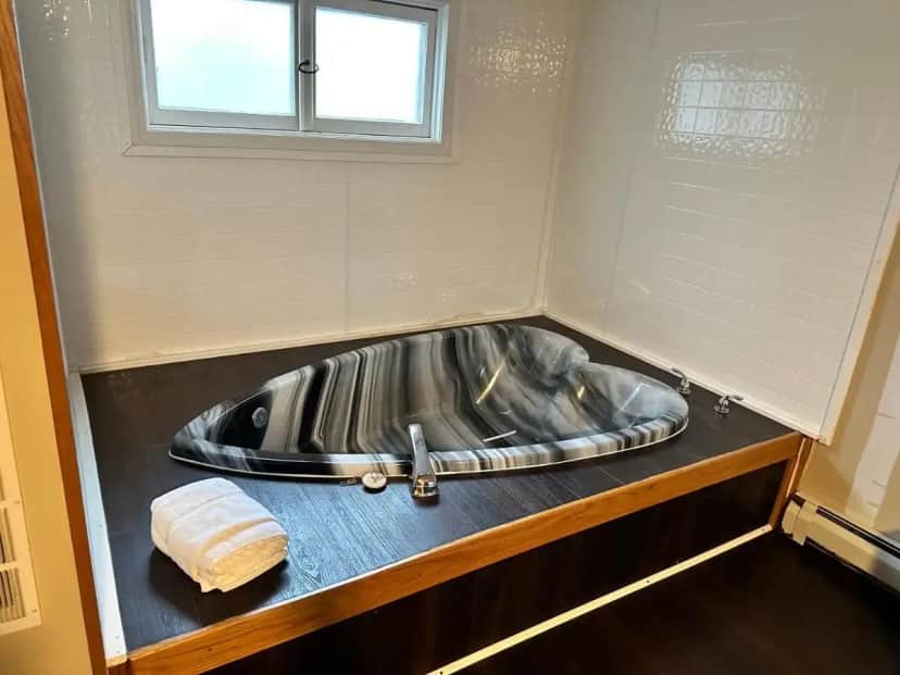 a bathroom with a metal sink and a towel at Cedar Hill Lodge in Saint Ignace