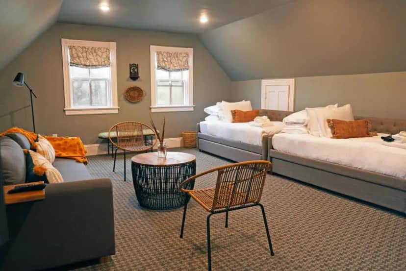 a living room with two beds and a couch at Chart House Inn in Newport