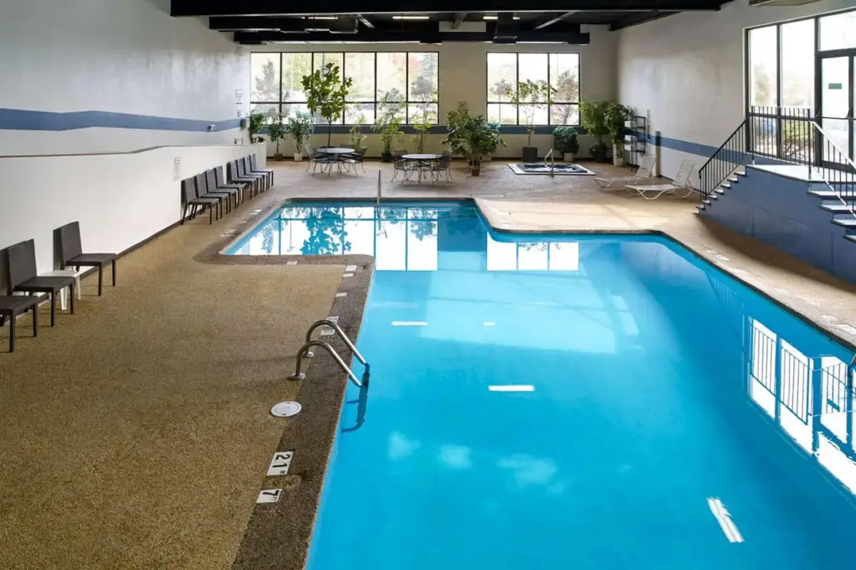 a large pool with blue water in a building at Clarion Hotel Portland Airport ME in Portland