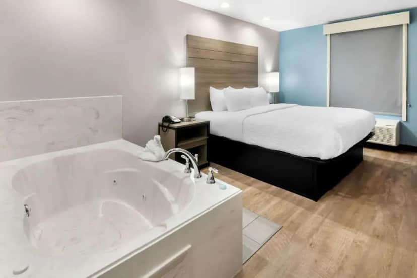 Private in-room jacuzzi in the King Room with Jacuzzi - Non Smoking/Interior Hall at Clarion Pointe Fort Worth East - Arlington