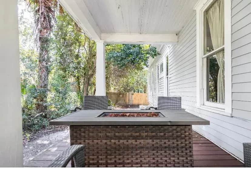 a patio with a fire pit on the side of a house at Classic/Modern Downtown Home in Valdosta