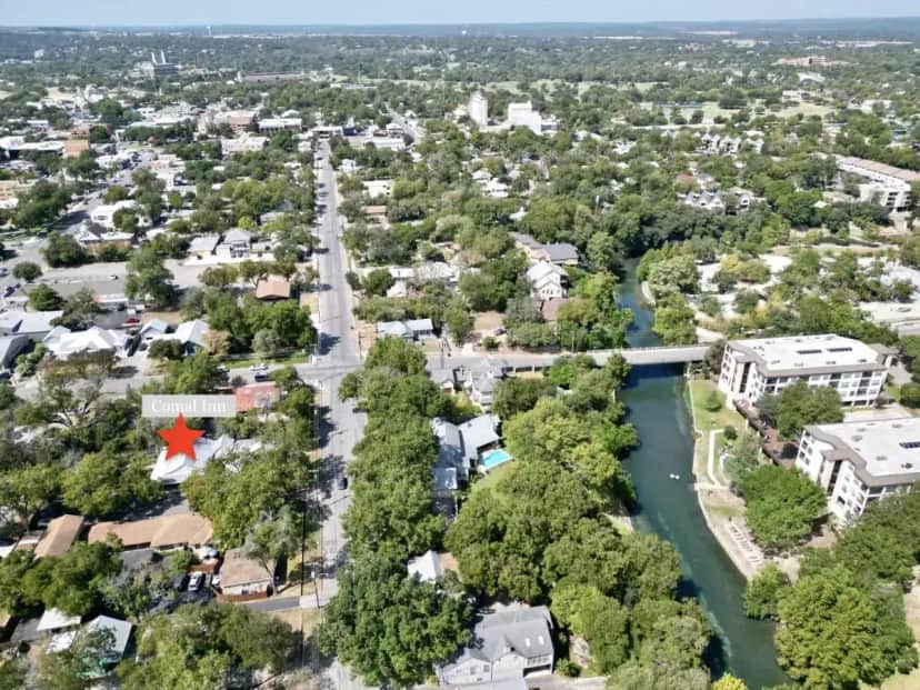 an aerial view of a city with a river at Comal Inn in New Braunfels