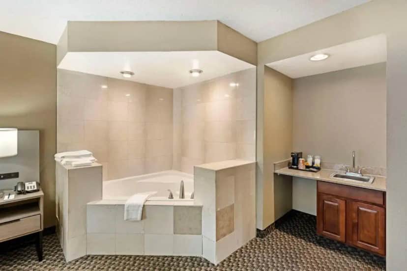 a large bathroom with a tub and a sink at Comfort Inn & Suites Carneys Point - Pennsville in Carneys Point