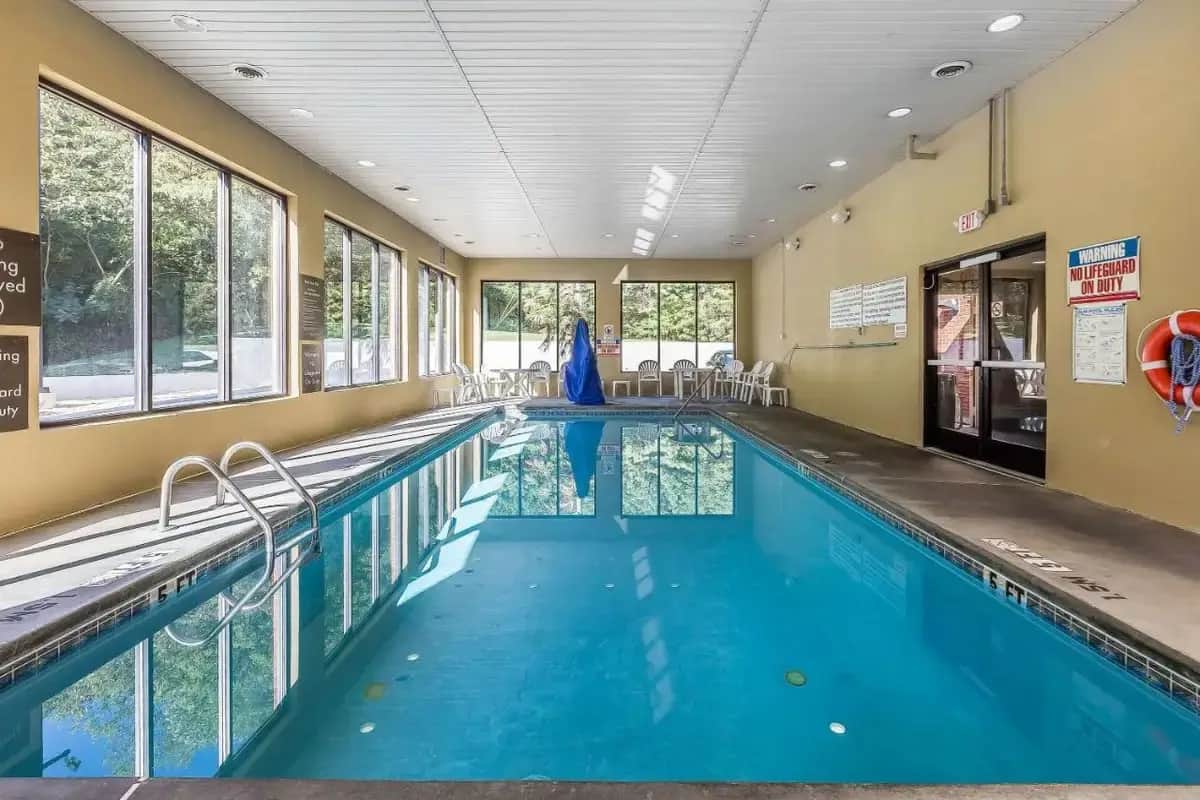 a swimming pool with blue water in a building at Comfort Inn & Suites Dalton West in Dalton