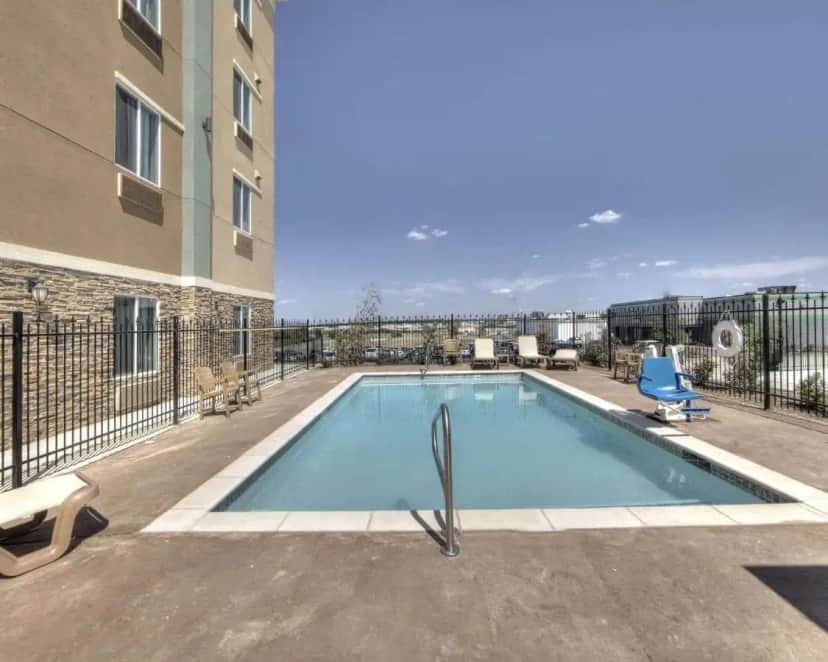 a swimming pool in front of a building at Comfort Inn & Suites Fort Worth West I-30 NAS JRB in Fort Worth