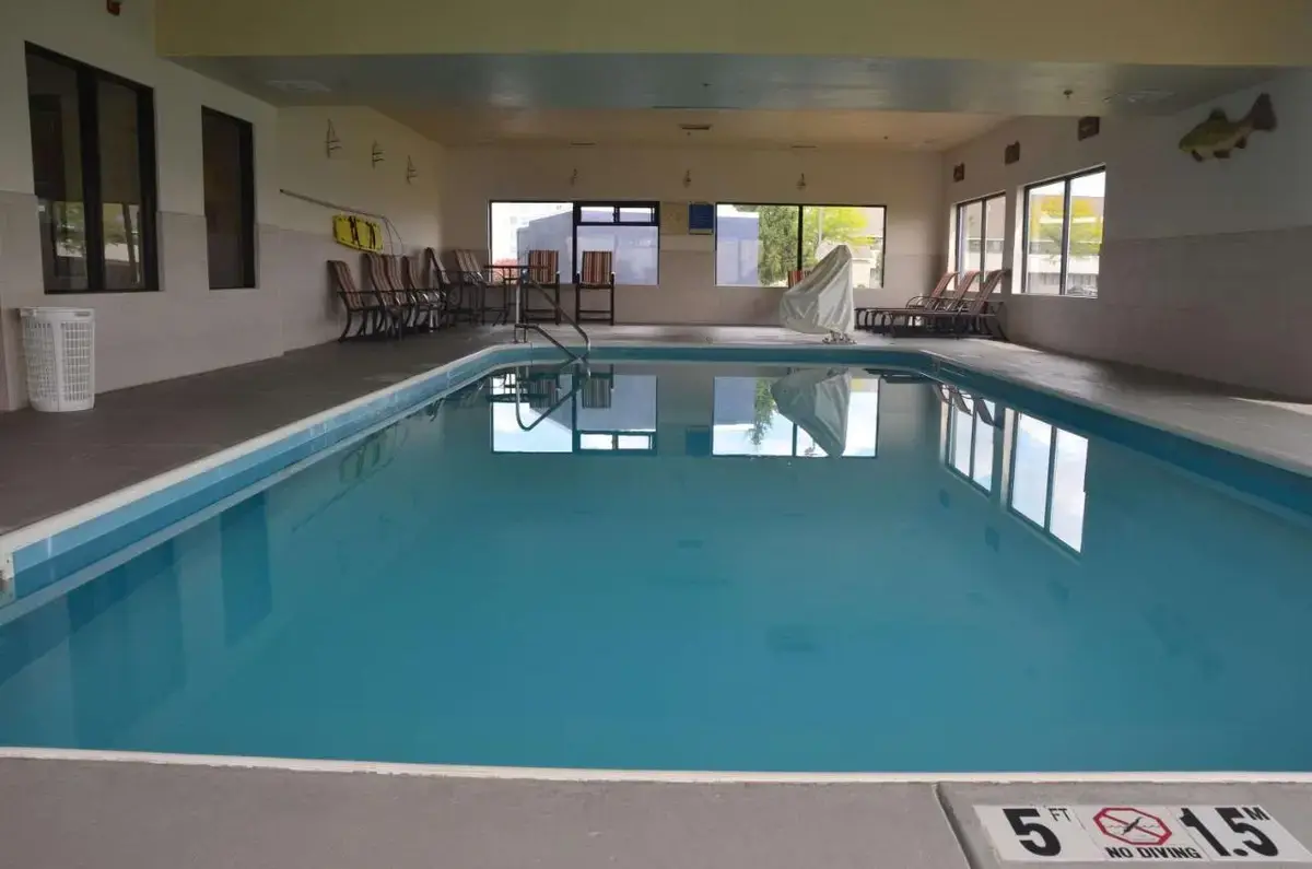 a large swimming pool with blue water in a building at Comfort Inn & Suites Maumee - Toledo I80-90 in Maumee