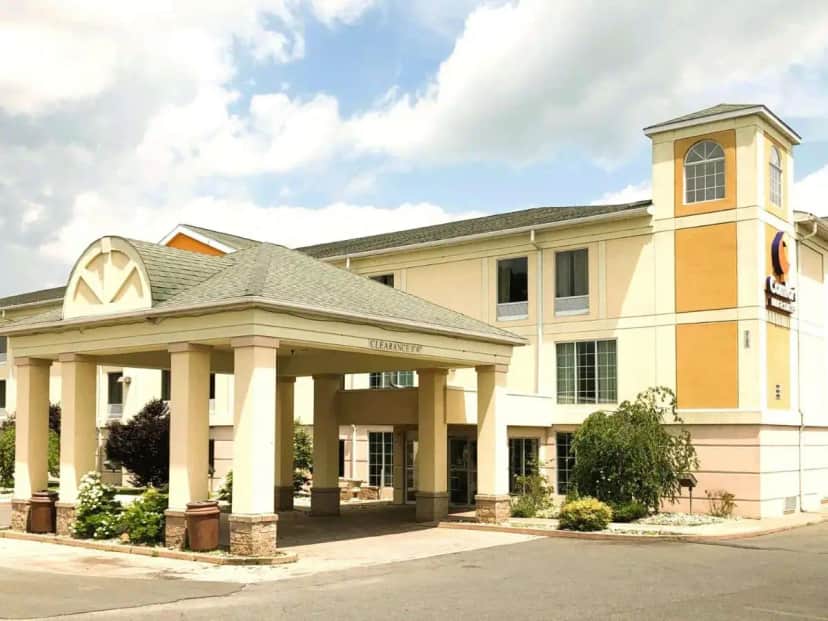 a large building with a clock on the front at Comfort Inn & Suites Mount Pocono in Mount Pocono